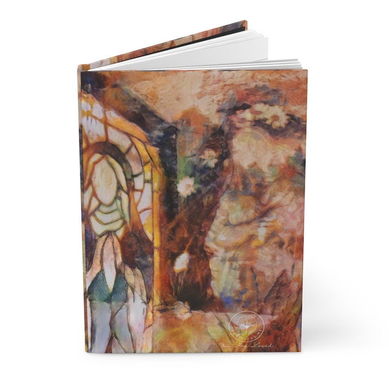 May include: Hardcover journal with an artistic, abstract painting on the cover. The artwork features warm tones of brown, orange, and yellow, with hints of green and white. The design includes a stained-glass window and floral elements.