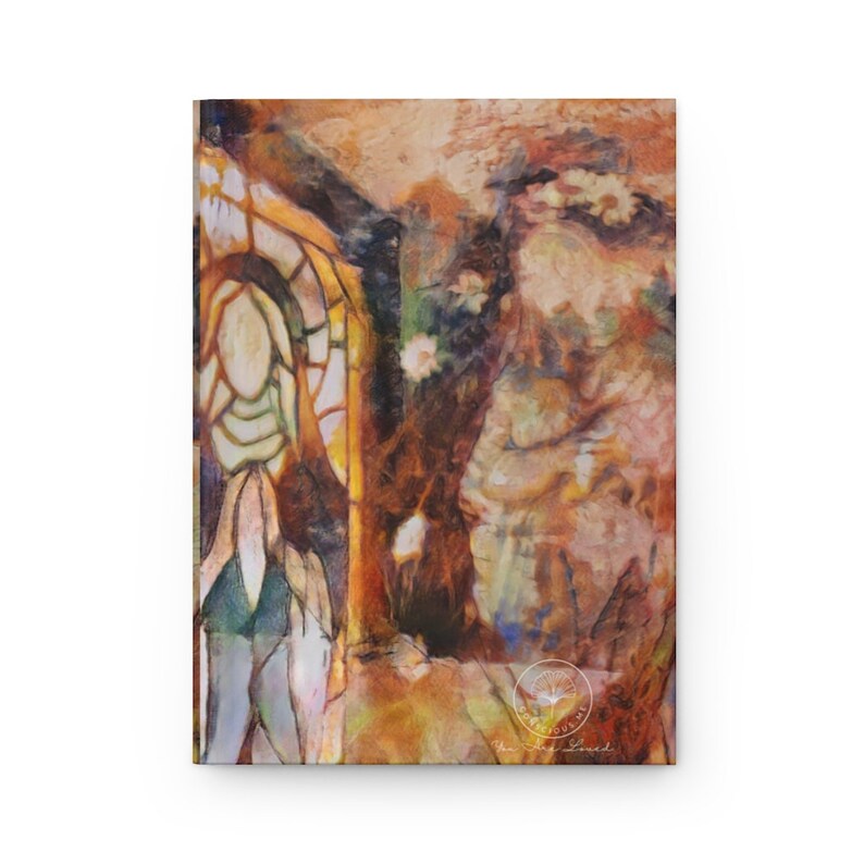 May include: A hardcover journal featuring an abstract painting in warm tones of brown, orange, and yellow. The artwork depicts a figure with a floral crown and a stained-glass window. The journal has the text "You Are Loved" on the bottom right.