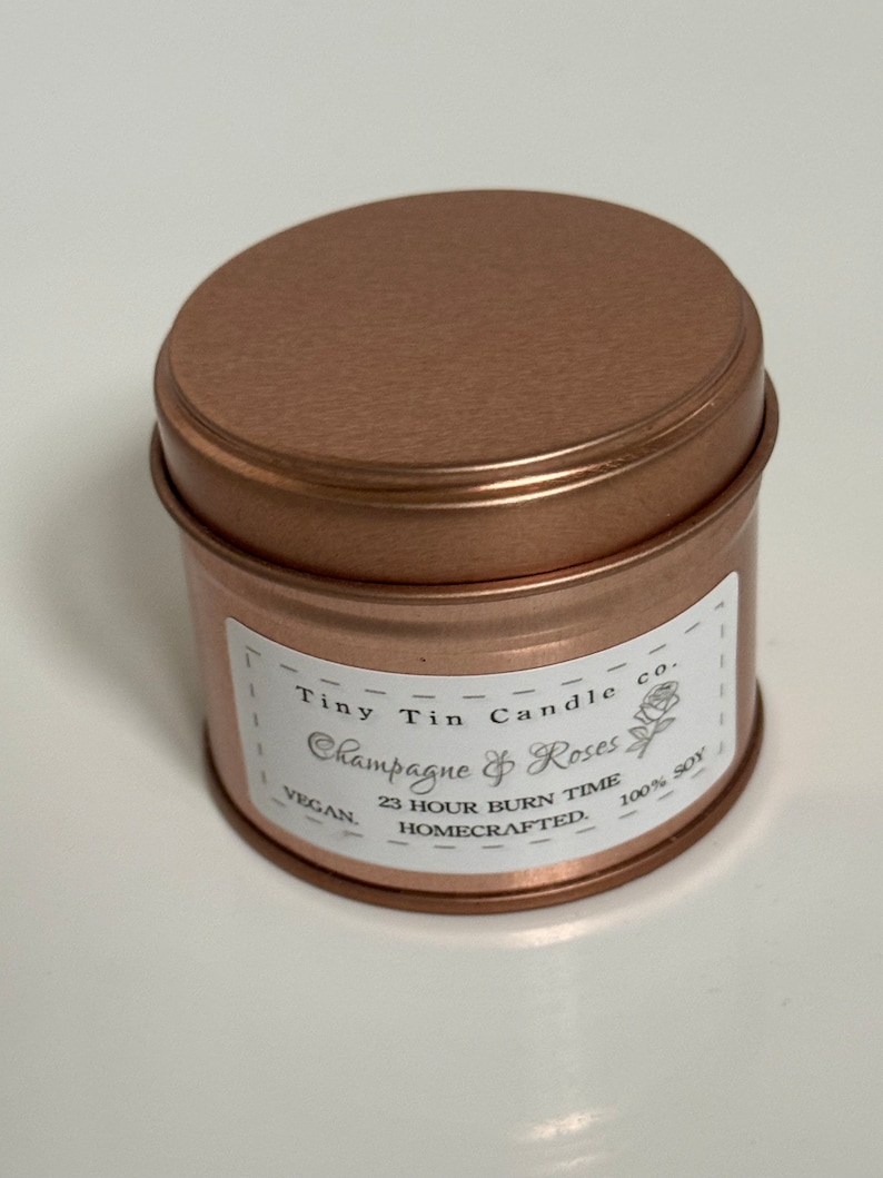 Homemade Candle Champagne & Roses Soy Tin Candle 100ml Tin. Front of candle with lid on.