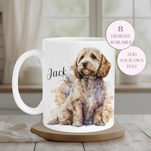 May include: White ceramic mug featuring a watercolor illustration of a dog named Jack. The dog is light brown with a fluffy coat. The mug has a curved handle and the text "8 Designs Available" and "Add Your Own Text" are also visible.