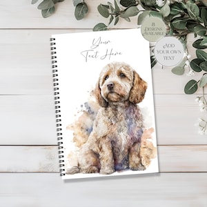 Könnte beinhalten: Ein spiralgebundenes Notizbuch mit einer Aquarellillustration eines hellbraunen, lockigen Hundes. Das Cover enthält den Text 'Your Text Here' sowie zwei kreisförmige Abzeichen mit der Aufschrift '8 Designs Available' und 'Add Your Own Text'.