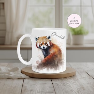 White ceramic mug personalised with the name “Charlotte” and featuring a striking red panda artwork in vibrant watercolour tones. A unique animal-themed gift for wildlife enthusiasts, red panda collectors and nature lovers. Suitable for birthdays, Christmas and other special occasions.