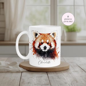 Cute personalised red panda mug showcasing a colourful watercolour illustration of one of the world's most loved animals. Customised with a name of your choice, this ceramic mug is perfect for animal lovers, wildlife fans and thoughtful personalised gifting. Eight designs available.