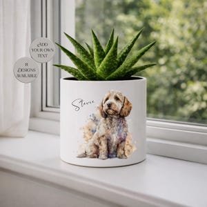 May include: White ceramic planter with a watercolor illustration of a dog named "Stevie." The planter holds a green succulent plant. Text on the planter reads "Add Your Own Text" and "8 Designs Available."