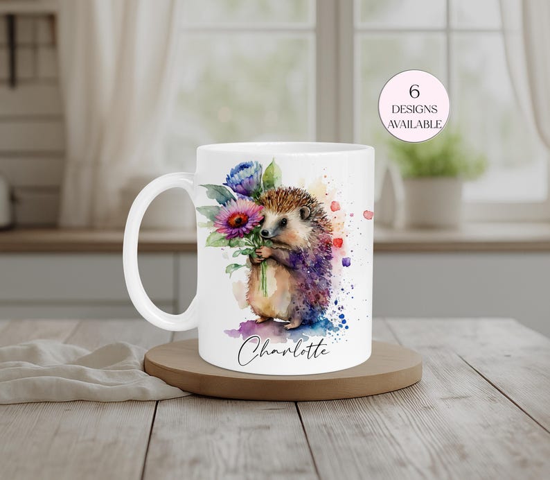 Watercolour hedgehog personalised mug with floral bouquet and custom name “Charlotte” printed on a white ceramic coffee cup, cute animal gift for her,