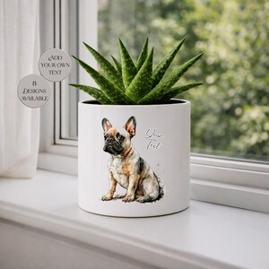 May include: A white ceramic planter with a watercolor illustration of a French Bulldog. The planter holds a green succulent plant. Text on the planter says "Add Your Own Text" and "Your Text". Additional text indicates "8 Designs Available".