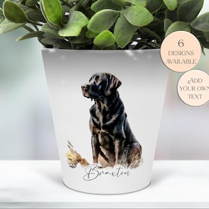 May include: White ceramic planter featuring a watercolor illustration of a black Labrador Retriever. The dog is sitting, with the name "Braxton" in script below. Two circular stickers read "6 Designs Available" and "Add Your Own Text".