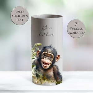 May include: A cylindrical, gray ceramic vase featuring a watercolor illustration of a smiling chimpanzee. The vase has the text "Your text here" and "Add your own text" and "7 designs available" in a circular design.
