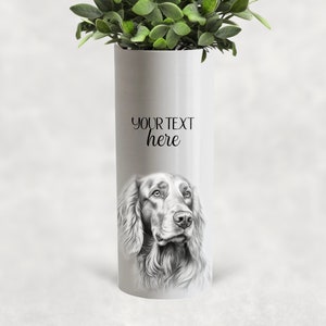 May include: A white cylindrical vase with a detailed pencil drawing of a dog's face. The vase has the text "YOUR TEXT here" in a script font. The vase is filled with green leafy plants.