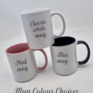 May include: Three white ceramic mugs with different color accents and text. One mug has a pink interior and handle, another has a blue interior and handle, and the third is all white. The text on the mugs reads "Classic white mug", "Pink mug", and "Blue mug". The text "Mug Colour Choices" is also present.