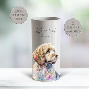 May include: A cylindrical white ceramic vase featuring a watercolor illustration of a Cocker Spaniel. The vase has the text "Your text here" and "Add your own text" and "8 designs available" in a circular design.