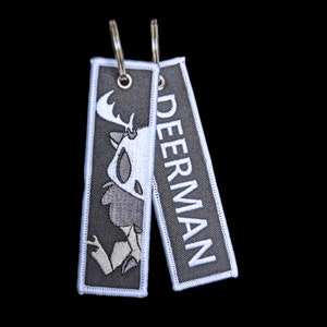 Cryptid jet tag keychains: Mothman, Deerman, Squonk, Nightcrawler