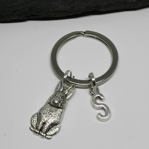 Puede incluir: Llavero plateado con un dije de conejo detallado y un dije con la inicial "S". El llavero tiene un anillo grande y redondo para llaves. El dije de conejo está intrincadamente diseñado. Un accesorio encantador.