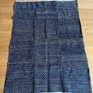 May include: A blue and white patterned rug with a woven texture. The rug is made of a soft, durable material and is perfect for adding a touch of style to any room.