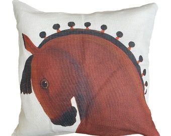 May include: Square throw pillow with a horse head design. The pillow features a white background with a large brown horse head illustration. The horse has a black mane and a decorative black and orange design along the top of its head.