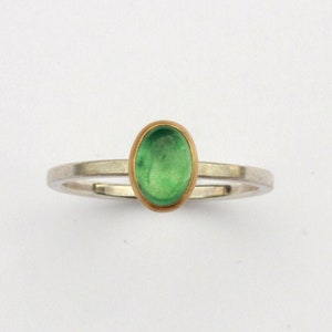 Silver ring with emerald in gold setting