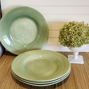 May include: A rustic wooden sign with the text "Welcome to our home" in white lettering. The sign features a distressed finish and a simple, inviting design, perfect for front door decor.