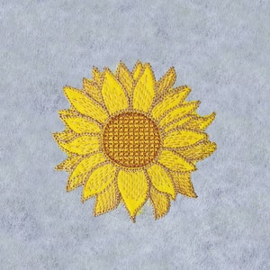 May include: A yellow embroidered sunflower with a brown center on a gray background.