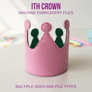 May include: A pink felt crown with a green interior, designed for machine embroidery. The crown has a stitched edge and three rounded points. Text on the image reads "ITH CROWN MACHINE EMBROIDERY FILES" and "MULTIPLE SIZES AND FILE TYPES".