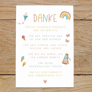 May include: A colorful thank you card with illustrations of a kite, ice cream cones, butterflies, a rainbow, and a xylophone. The card says "Danke" and includes the text "For the beautiful moments and experiences, for the comfort and holding in your arms, for the singing and reading, playing and laughing, for all the things I learned, for your tireless patience, for the colorful and joyful time."