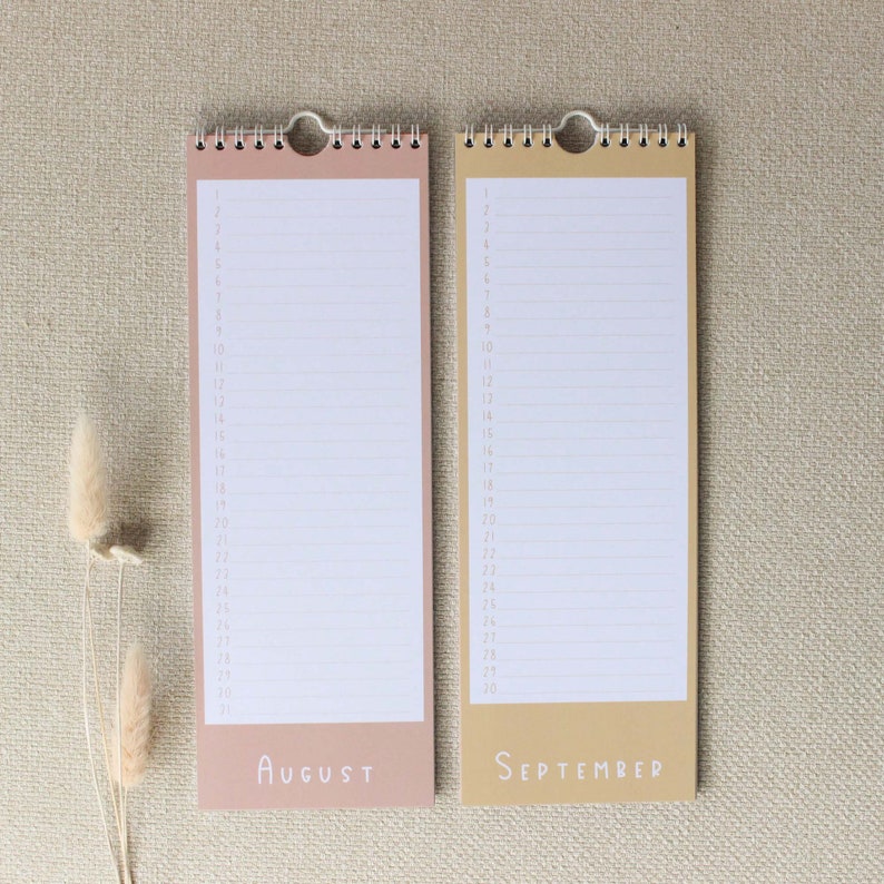 May include: Two blank monthly calendars, one in peach and one in beige, with the months August and September printed at the bottom.