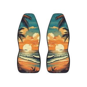 May include: A pair of black and teal car seat covers with a sunset beach scene. The scene features palm trees, a setting sun, and ocean waves.