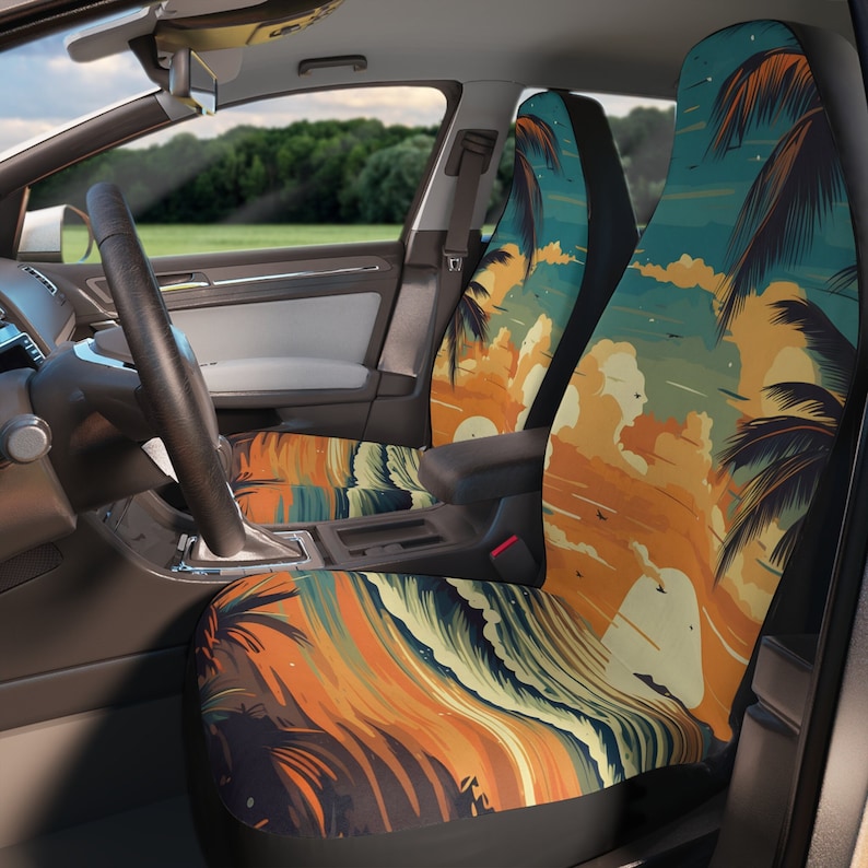 May include: A pair of car seat covers with a tropical sunset design. The covers feature palm trees, waves, and a sunset sky in shades of orange, yellow, blue, and green.