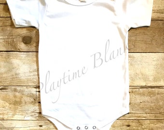 May include: White baby onesie with short sleeves and snap closures. The onesie is blank and ready for customization.
