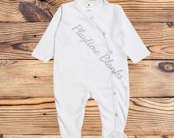May include: White baby onesie with long sleeves and a snap closure on the front. The onesie has the text "Playtime Blankets" printed on the front.