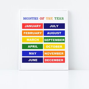 May include: A white framed chart with the title "MONTHS OF THE YEAR" in colourful letters. The months of the year are listed in two columns, with each month written in white letters on a coloured rectangle. The colours of the rectangles are red, orange, yellow, green, blue, and purple.