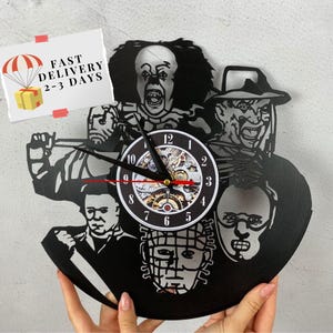 May include: Black vinyl record clock featuring iconic horror movie characters, including Freddy Krueger, Jason Voorhees, Michael Myers, and Leatherface. The clock has a black background and a silver clock face with black numbers.