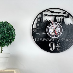 May include: Black vinyl record clock featuring a silhouette of the Hogwarts Express train with the text "HOGWARTS EXPRESS 9 3/4".