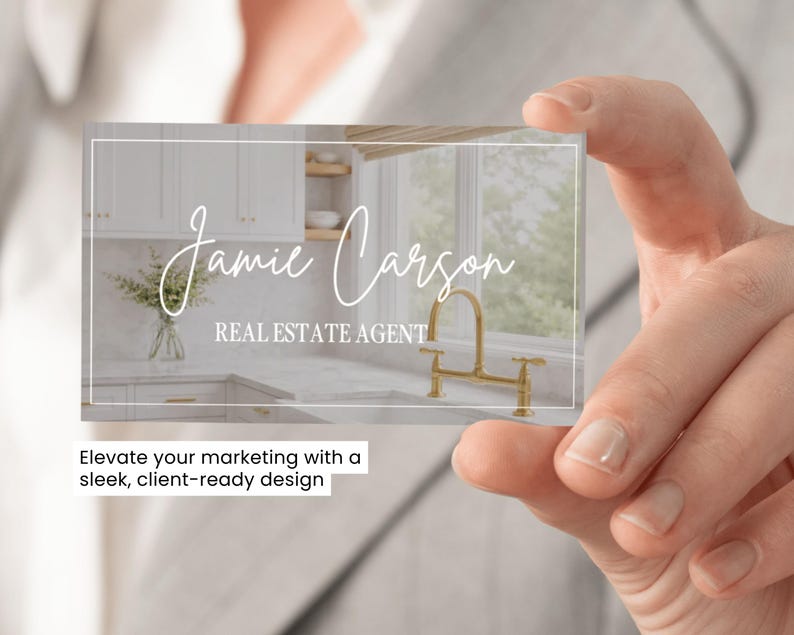 May include: A rectangular business card featuring a white border and a background image of a kitchen with white cabinets, marble countertops, and a gold faucet. The text Jamie Carson is written in a white script font, with REAL ESTATE AGENT below.