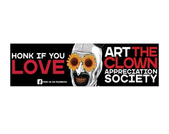 May include: A banner with a black background featuring the text "HONK IF YOU LOVE" in red and white. The image includes a clown face with sunflower-shaped glasses and the text "ART THE CLOWN APPRECIATION SOCIETY".