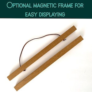 May include: Wooden magnetic frame for easy displaying. The frame consists of two light brown wooden bars connected by a brown string. The text "OPTIONAL MAGNETIC FRAME FOR EASY DISPLAYING" is at the top of the image.