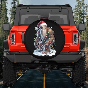 Bronco Bigfoot Christmas Spare Tire Cover,Big Foot Christmas 2025 Tire Cover, Sasquatch Xmas Lights Tire Cover, Yeti Bigfoot Tire Cover