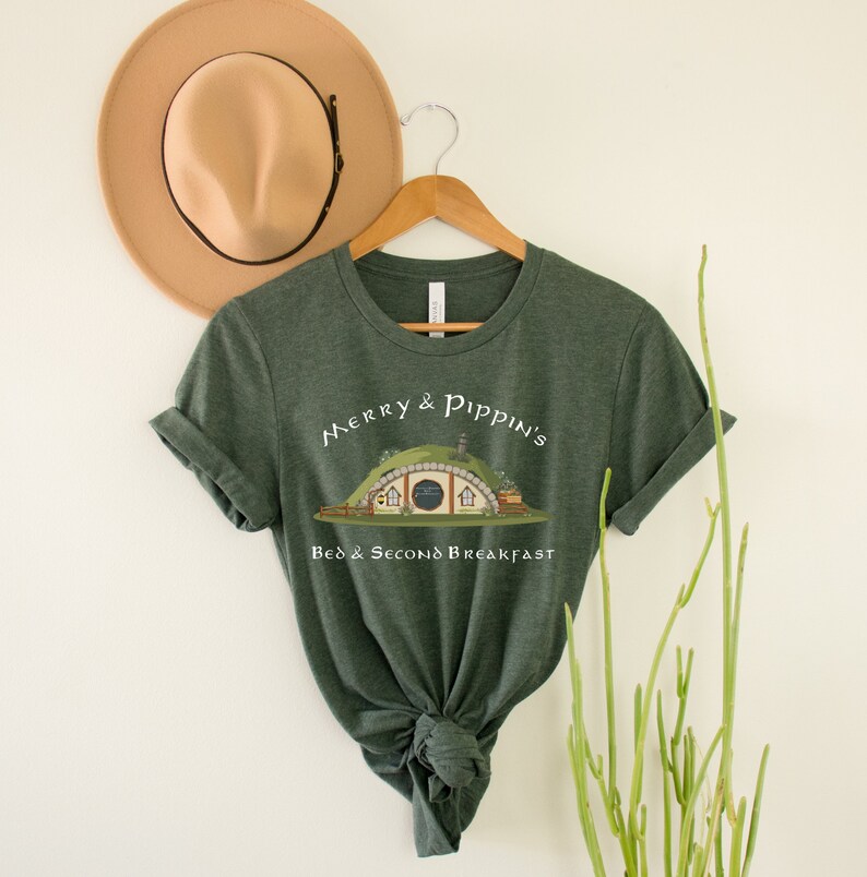 May include: A green t-shirt with a graphic of a hobbit hole and the text "Merry & Pippin's Bed & Second Breakfast".