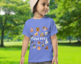 May include: A blue toddler t-shirt featuring various dog breeds with the text "I LOVE DOGS" in white. The shirt has a crew neck and short sleeves. The design includes cartoon illustrations of different dog faces.