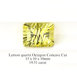 May include: A faceted, lemon-yellow quartz gemstone with an octagon concave cut. The stone measures 15 x 10 x 10mm and weighs 19.51 carats. The gemstone is set against a white background.