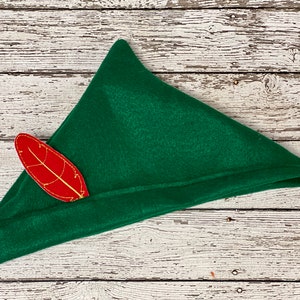 May include: A green felt elf hat with a red felt leaf sewn on the side.