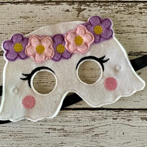 May include: White felt ghost mask with pink and purple flower accents and black elastic strap.
