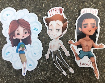 Op de afbeelding: Drie eigenzinnige stickers met cartoonfiguren. Eén toont een vrouw met een plant, omringd door wolkenvormen met de tekst "HOA". Een andere toont een man zonder shirt met de tekst "TITSQAK". De laatste sticker toont een man met de tekst "WTHHYB" en "Loca?"