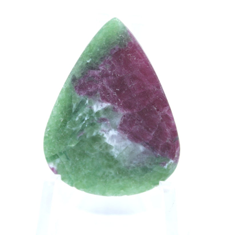 May include: A green and pink gemstone cabochon cut in a teardrop shape. The stone has a swirling pattern of green, pink, and white.
