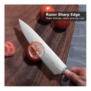 May include: A stainless steel chef's knife with a patterned blade slicing through a tomato on a wooden cutting board. The text "Razor Sharp Edge" and "Make thinner, more precise cuts" is visible in the image.
