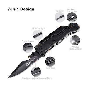 May include: Black multi-tool knife with a stainless steel half serrated blade. Features include a bottle opener, LED flashlight, and window/glass breaker. The blade is engraved with the name "Cameron". The text "7-In-1 Design" is visible.