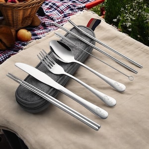 May include: A set of stainless steel cutlery with a gray felt carrying case. The set includes a knife, fork, spoon, chopsticks, and two straws with a cleaning brush. The cutlery is engraved with the word "Olivia".