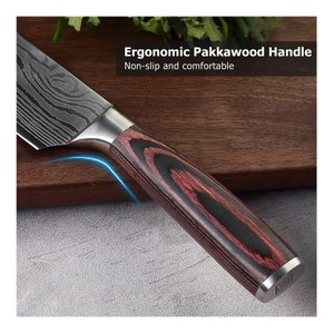 May include: Close-up of a kitchen knife with a patterned blade and a Pakkawood handle. The handle is a combination of dark red and black wood. The text in the image reads: "Ergonomic Pakkawood Handle. Non-slip and comfortable."