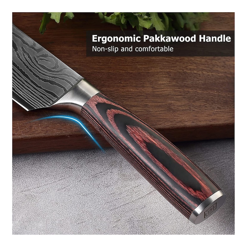 May include: Close-up of a kitchen knife with a patterned blade and a Pakkawood handle. The handle is a combination of dark red and black wood. The text in the image reads: "Ergonomic Pakkawood Handle. Non-slip and comfortable."