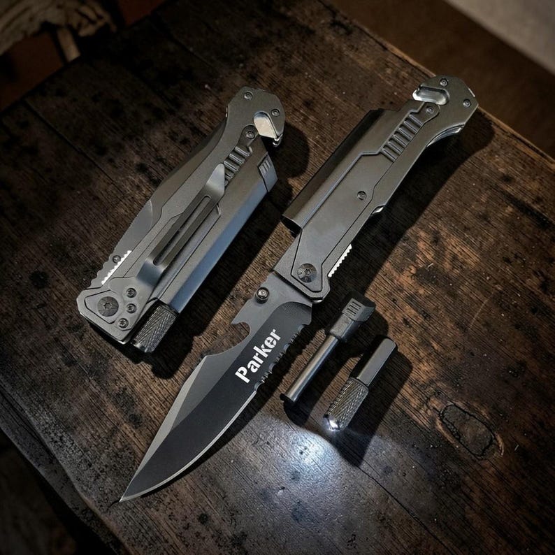 May include: A set of silver-colored knives and tools, including a partially open folding knife with the name "Parker" on the blade. The set includes a fire starter and a small, rectangular tool. The items are arranged on a dark wooden surface.