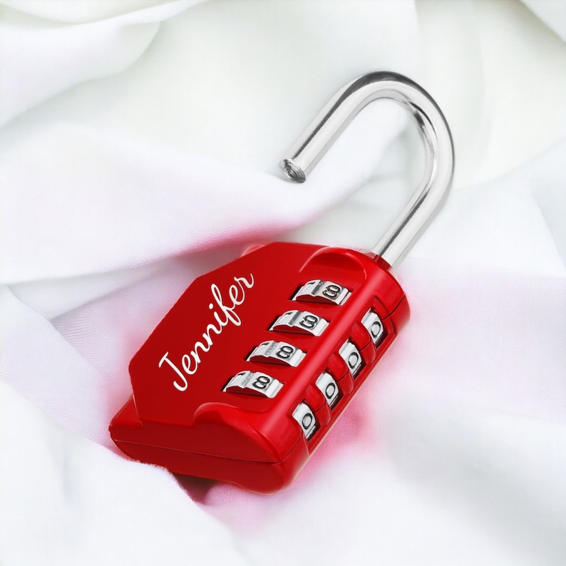 May include: Red combination lock with a silver shackle and the name "Jennifer" printed on the side. The lock has four dials with numbers 0-9.